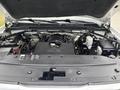 Engine compartment of a 2016 GMC Sierra 1500 showcasing the V8 engine along with various components such as the battery and air intake system