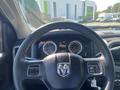 Steering wheel and dashboard of a 2015 RAM 2500 showing gauges and controls