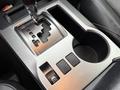Close-up of the gear shift and center console of a 2018 Toyota 4Runner featuring a silver gear selector and control buttons