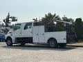 A white 2006 Sterling Acterra truck with a utility bed and mounted crane on the rear