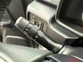 Close-up of a 2018 Toyota 4Runner steering column featuring a multifunction lever for headlights turn signals and fog lights