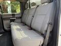 The interior of a 2020 Ford F-350 SD showing a spacious backseat with gray fabric upholstery and seatbelts