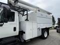 A 2006 International 4300 bucket truck with an elevated boom and a white utility box on the side
