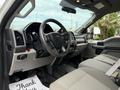 Interior view of a 2019 Ford F-350 SD showcasing the steering wheel dashboard and seats with a focus on fabric textures and controls