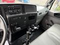 Interior view of a 2022 International MV607 showing the dashboard with control panel radio and cup holder along with the driver's seat and gear shift