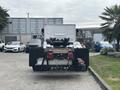 A 2020 Lion Lion6 electric truck is shown from the rear with a flatbed and visible taillights in the foreground