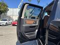 A 2015 RAM 1500 truck with an open driver's side door showcasing its interior features and panel design