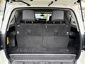 The interior of a 2018 Toyota 4Runner with the rear seat folded down showing a spacious trunk area with black carpet and two headrests visible