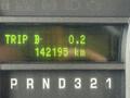 A 2009 Ford Econoline dashboard display showing trip details with a mileage reading of 142193 km and trip D at 0.2 km
