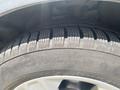 Close-up of a tire on a 2015 Ford Escape showing tread pattern and brand name Nokian Tyres