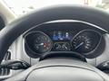 A 2018 Ford Focus dashboard displaying speedometer fuel gauge and warning lights with a steering wheel partially visible