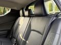 Interior view of the back seat of a 2021 Toyota C-HR featuring black upholstery with two headrests and a textured pattern on the seatbacks
