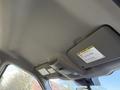 Interior roof view of a 2020 Ford F-550 featuring overhead controls and a warning label on the visor