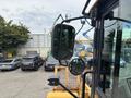 A 2012 Caterpillar 980 wheel loader with a large front bucket and a cabin view showing mirrors and controls