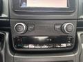 Dashboard controls of a 2023 RAM Promaster 3500 featuring knobs for volume and tuning along with an interface for climate control and screen options