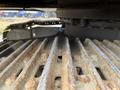 Close-up of the rusty metal tracks of a 2018 John Deere 350 showing grooves and wear patterns