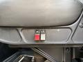 Two buttons on a control panel of a 2011 International 7500 truck seat one is red and the other is gray