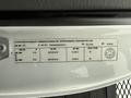 A manufacturer's label attached to a vehicle featuring specifications like model number tire size and weight capacity