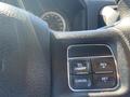 Close-up of the control panel on a 2015 RAM 2500 steering wheel featuring buttons for on/off cancel and set for cruise control