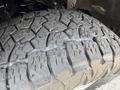 Close-up of a heavily treaded tire from a 2021 Ford F-150 showcasing deep grooves and rugged texture designed for traction and durability