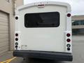 Rear view of a white 2017 Chevrolet Express van with red taillights and large windows