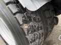 Close-up of a treaded tire from a 2009 UD Trucks UD 3300 with a small leaf resting on the surface