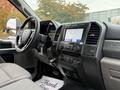 Interior view of a 2022 Ford F600 showing the dashboard steering wheel and controls with a touchscreen display
