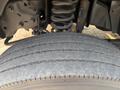 Close-up of a worn tire on a 2009 Ford F-550 showing visible tread wear and damage