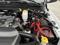A close-up view of the engine compartment of a 2024 RAM 5500 showcasing the engine components battery wiring and fluid reservoir
