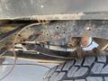Close-up of the undercarriage of a 2016 Ford F-350 SD showcasing the frame axle and tire tread details