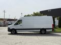 A 2023 Mercedes-Benz Sprinter van in white with a sleek design and no windows on the sides