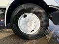 Close-up of a tire mounted on a 2010 International 4300 featuring a white rim and distinctive tread pattern