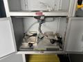 Interior view of a 2020 Mercedes-Benz Sprinter 2500 showing a built-in sink with plumbing and two metallic tanks secured with straps
