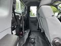 Interior view of a 2013 Ford F-250 SD showing the rear seating area with gray upholstery and seatbelts
