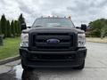 A 2015 Ford F-350 SD with a black front grille and orange clearance lights displayed prominently in the foreground