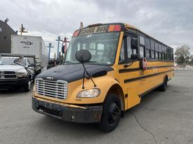 A yellow 2007 Freightliner B2 school bus with large windows and a stop sign on the side is parked, displaying the number 4340 on the front