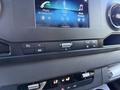 Dashboard of a 2023 Mercedes-Benz Sprinter 2500 featuring a touchscreen display with icons for phone radio media and Bluetooth controls and various buttons for vehicle settings