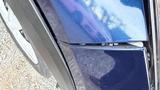 A close-up view of the blue front fender of a 2019 Nissan Kicks highlighting the curves and detailing of the car's design