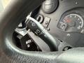 A steering column with a multifunction lever for windshield wipers and headlights in a 2012 Ford Econoline