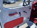 Interior view of a 1962 Ford 2WHDR door panel featuring red quilted upholstery and various controls including a door handle and window crank