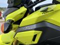 A bright yellow 2018 Honda Grom motorcycle featuring a sleek design with the brand name GROM prominently displayed on the body and the Honda logo on the front