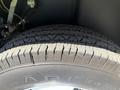 Close-up view of a tire from a 1976 GMC Palm Beach showcasing tread patterns and the brand Laredo embossed on the sidewall