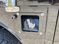 Close-up of the fuel filler cap for a 2022 Ford F-350 SD showing the access compartment and securing hardware