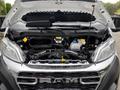 A 2023 RAM Promaster 3500 with its hood lifted showing the engine compartment and various mechanical components inside