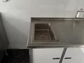 Stainless steel countertop with a sink insert designed for commercial food preparation