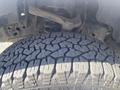 A close-up view of a rugged tire with deep treads mounted on a 2017 Ford F-150 showcasing its sturdy grip and texture