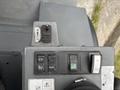 Control panel of a 2014 Wacker Neuson WL34 featuring switches for functions including auxiliary controls and icons indicating various machine operations