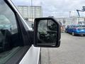 A close-up of the side mirror of a 2018 Ford F-150 showing a clear reflection and angular design