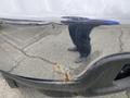 A 2003 Ford F-450 SD with a shiny bumper that has a rust spot near the bottom