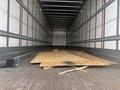 An empty 45-foot Great Dane trailer with a wooden plank and some debris on the floor
